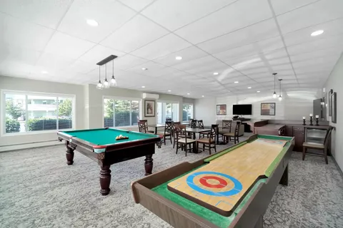 Games room with a shuffleboard table and pool table