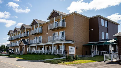 Three-storey residence with balconies, a covered porch and lawn