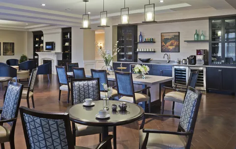 Bistro with tables, chairs and a dark counter.