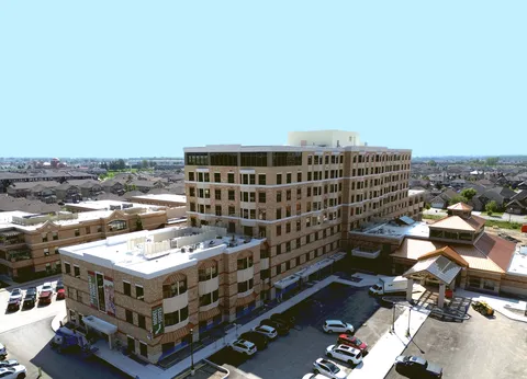 Aerial view of the residence buildings, surrounding streets and parked vehicles