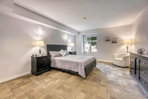 Bedroom with a bed, bedside tables and a dark headboard