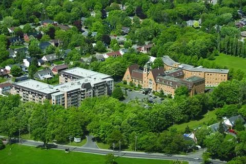 Aerial view of residence buildings surrounded by mature trees