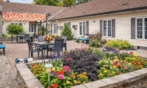 Courtyard patio with seating and planted flower beds.