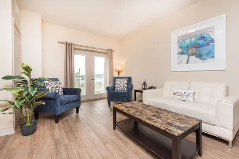 Suite sitting area with a sofa, two armchairs and a coffee table.