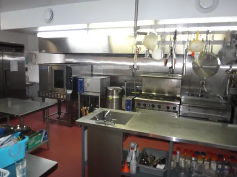 Kitchen with stainless steel counters, ovens and cooking equipment