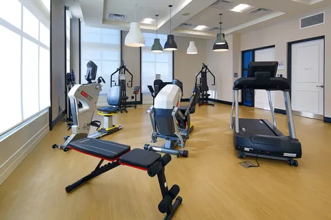 Fitness room with exercise bikes, treadmills and strength equipment.