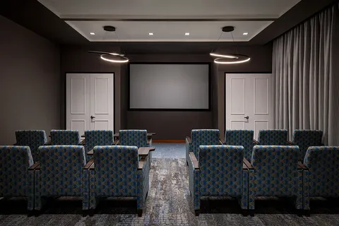 Screening room with rows of seats and a large screen.