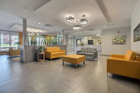 Lobby sitting area with yellow sofas and chairs.