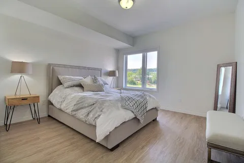 Bedroom with a bed, bedside table and window.