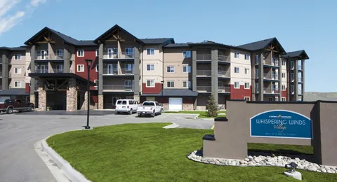 Multi-storey residence with balconies, a covered entrance and front lawn