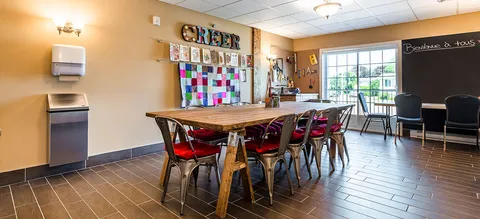 Craft room with tables, chairs and display boards.