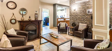 Bistro sitting area with a fireplace and leather chairs.