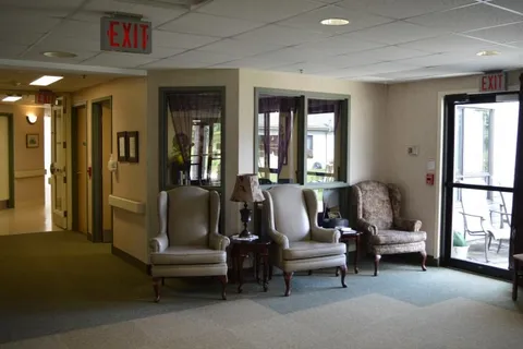 Armchairs in a carpeted sitting area near the entrance