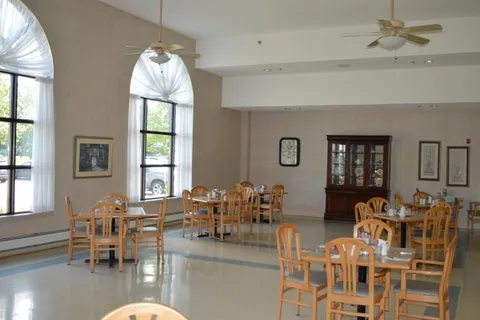 Dining room with wooden tables and arched windows