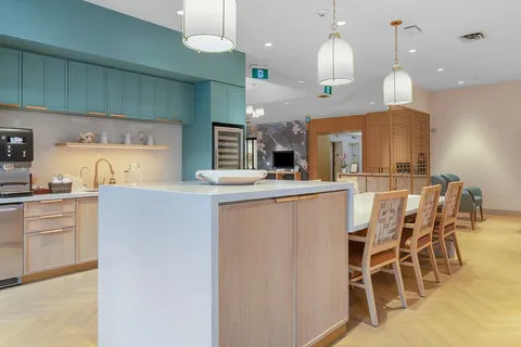Bistro with a pale wood counter, stools and pendant lights.