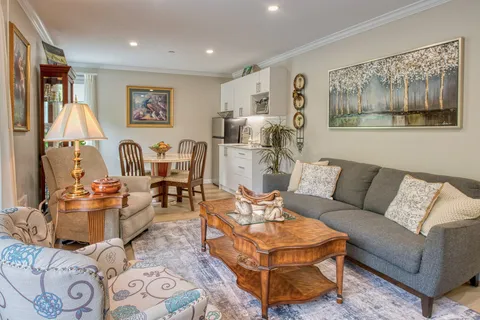 Suite living room with a sofa and adjoining kitchenette