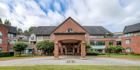 Front exterior with a covered drive-up entrance