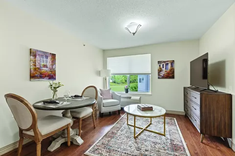 Room with a table, armchair and television