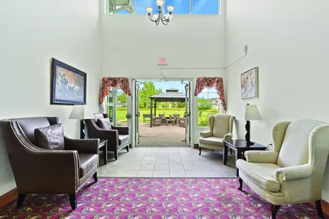 Room with armchairs beside glazed doors and windows