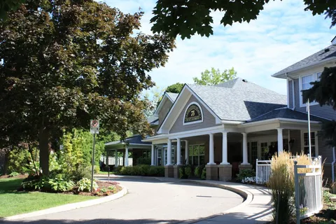 Residence building beside a curved entrance drive.