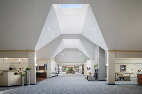 Entrance lobby with a vaulted ceiling, counters and seating.