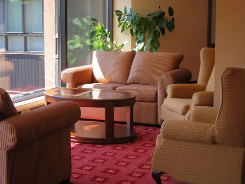 Armchairs and a coffee table beside large windows