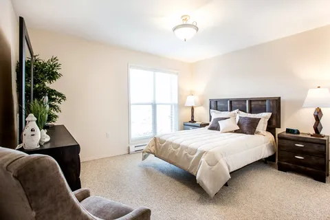 Bedroom with a double bed, bedside tables and a large window