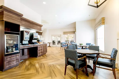 Tables and patterned chairs beside a coffee counter