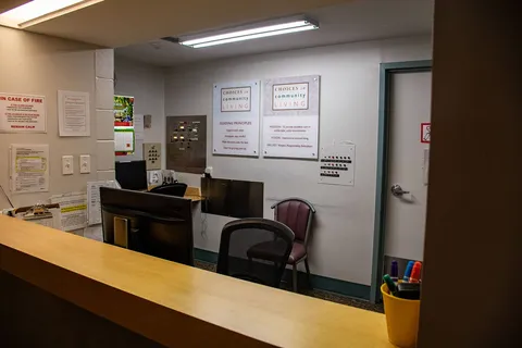 Reception desk with an office chair, paperwork and wall notices