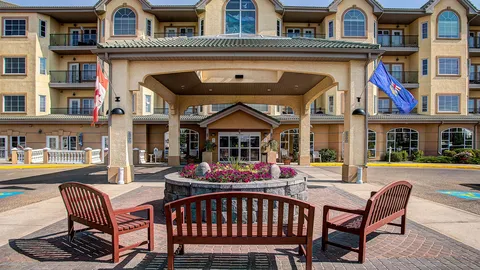 Residence exterior with a covered entrance and patio seating.