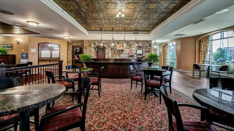 Common room with tables, chairs and a bar counter.