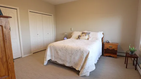 Bedroom with a bed, closet and window.