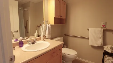 Bathroom with a vanity, mirror and toilet.