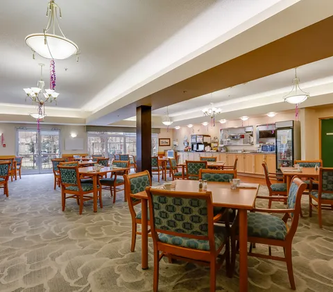 Dining room with wooden tables, chairs and a service counter.