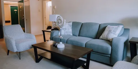 Suite sitting area with a sofa, armchair and coffee table.