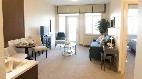 Suite sitting area with a sofa, television and round dining table