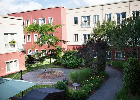 Residence buildings around a landscaped courtyard with paths and seating
