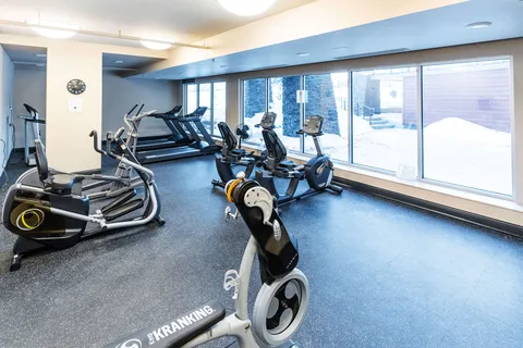 Exercise room with treadmills, stationary bicycles and large windows