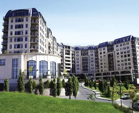 Multi-storey residence with balconies beside landscaped grounds