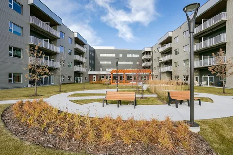 Residential wings around a courtyard with benches and a pergola