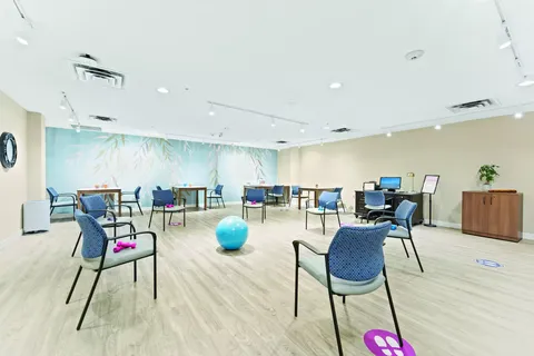 Exercise room with chairs, hand weights, a ball and a computer