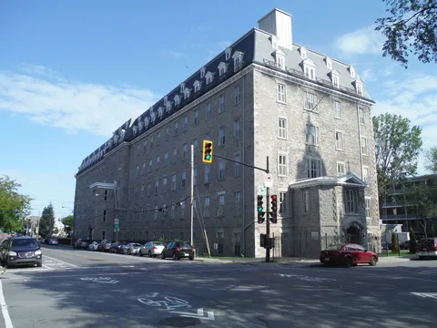 Historic stone residence building at a street corner.