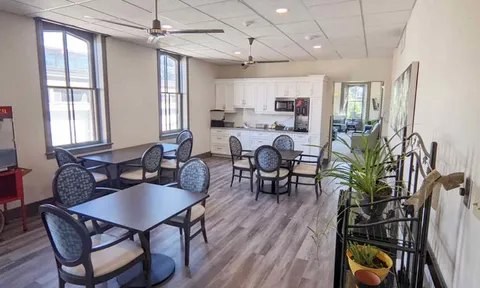 Seating tables beside a shared kitchenette