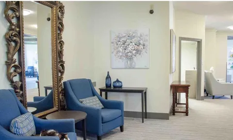 Armchairs beside a bright corridor and window