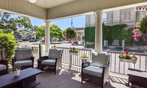 Covered porch with wicker chairs and tables