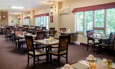 Dining room with set tables and wooden chairs