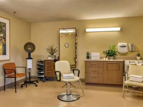 Hair salon with a styling chair, dryer, mirror and sink