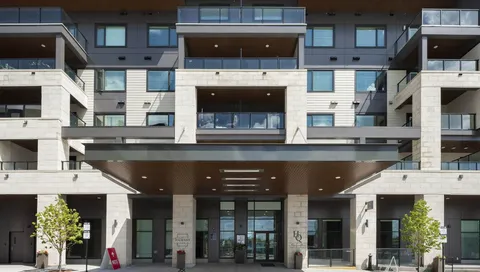 Residence facade with balconies above a covered main entrance.
