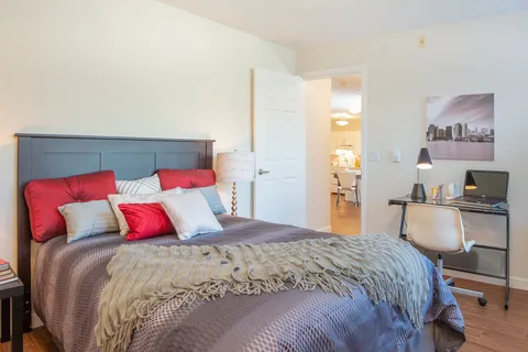Bedroom with a double bed, bedside table and lamp.