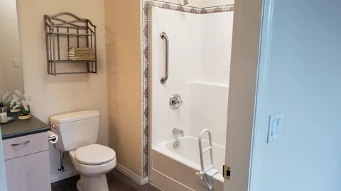 Suite bathroom with a shower, toilet and vanity.